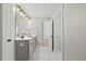 Stylish bathroom with double sinks, a large mirror, and modern lighting fixtures at 204 Woodstaff Ave, Wake Forest, NC 27587
