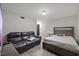 This large bedroom features a queen sized bed, hard wood floors, and a leather sofa at 204 Woodstaff Ave, Wake Forest, NC 27587