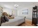 Cozy bedroom features a comfortable bed and stylish decor with neutral color palette and hardwood floors at 204 Woodstaff Ave, Wake Forest, NC 27587