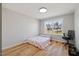 Bright bedroom with a large window, hardwood floors, and a neutral color scheme at 204 Woodstaff Ave, Wake Forest, NC 27587
