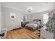 Cozy bedroom with hardwood floors, natural light, and a comfortable bed at 204 Woodstaff Ave, Wake Forest, NC 27587