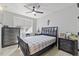 Well-lit bedroom with neutral walls, a fan, dark furniture, and a comfortable queen-sized bed at 204 Woodstaff Ave, Wake Forest, NC 27587