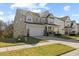 Attractive two-story home boasting a covered front porch and a convenient two-car garage at 204 Woodstaff Ave, Wake Forest, NC 27587
