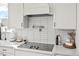 Close up of modern kitchen featuring white subway tile backsplash, quartz countertops and stainless steel pot filler at 204 Woodstaff Ave, Wake Forest, NC 27587