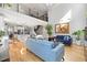 Open-concept living area with high ceilings, hardwood floors, and a view of the modern kitchen and staircase at 204 Woodstaff Ave, Wake Forest, NC 27587