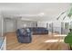 Open-concept living room with hardwood floors and cozy, modern furnishings at 204 Woodstaff Ave, Wake Forest, NC 27587