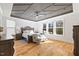 Spacious main bedroom with light wood floors, designer ceiling, and lots of light from multiple windows at 204 Woodstaff Ave, Wake Forest, NC 27587