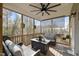 A cozy screened porch with comfortable seating and natural light at 204 Woodstaff Ave, Wake Forest, NC 27587