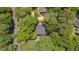 An aerial view of the home nestled among mature trees in the neighborhood at 207 Old Forest Creek Dr, Chapel Hill, NC 27514