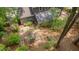 Aerial view of the backyard and patio, showing a mature tree, swing set, and lush landscaping at 207 Old Forest Creek Dr, Chapel Hill, NC 27514