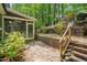 Backyard featuring lush foliage, access to the screened porch, and a playset at 207 Old Forest Creek Dr, Chapel Hill, NC 27514