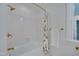 Bright bathroom showcasing a bathtub and shower with stylish gold fixtures and neutral finishes at 207 Old Forest Creek Dr, Chapel Hill, NC 27514