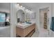 Bright bathroom featuring a double vanity with modern fixtures and stylish mirrors at 207 Old Forest Creek Dr, Chapel Hill, NC 27514