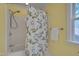 Bathroom featuring a white shower and floral shower curtain, adjacent to a window providing natural light at 207 Old Forest Creek Dr, Chapel Hill, NC 27514