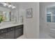 Elegant bathroom featuring marble countertops, dark wood cabinets, and gold fixtures at 207 Old Forest Creek Dr, Chapel Hill, NC 27514