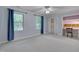 Comfortable bedroom with blue accent wall, large windows, and an attached sitting area at 207 Old Forest Creek Dr, Chapel Hill, NC 27514