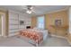 Bedroom with built-in bookshelves, ceiling fan and wall decor; lots of open space at 207 Old Forest Creek Dr, Chapel Hill, NC 27514