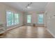 Bright bedroom with large windows providing natural light and hardwood floors at 207 Old Forest Creek Dr, Chapel Hill, NC 27514