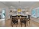Bright dining room featuring a wooden table, black chairs, built-in shelving, and a window seat at 207 Old Forest Creek Dr, Chapel Hill, NC 27514