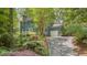 Charming two-story home features a brick walkway, mature landscaping, and a convenient attached garage at 207 Old Forest Creek Dr, Chapel Hill, NC 27514