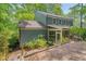 Exterior of home featuring screened porch and landscaped yard at 207 Old Forest Creek Dr, Chapel Hill, NC 27514