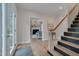 Welcoming foyer showcasing hardwood floors, staircase and an open view of the living area at 207 Old Forest Creek Dr, Chapel Hill, NC 27514