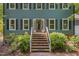 Welcoming front entrance with brick steps, white railings, and a stylish front door at 207 Old Forest Creek Dr, Chapel Hill, NC 27514