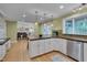 Open-concept kitchen with barstool seating, views into an open floorplan, and stainless appliances at 207 Old Forest Creek Dr, Chapel Hill, NC 27514