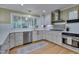 Bright kitchen with stainless steel appliances, tile backsplash and apron front sink under a window at 207 Old Forest Creek Dr, Chapel Hill, NC 27514