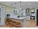 Modern kitchen featuring stainless steel appliances, a center island with stools, and ample counter space at 207 Old Forest Creek Dr, Chapel Hill, NC 27514