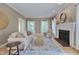 Spacious living room with hardwood floors, fireplace, and ample natural light at 207 Old Forest Creek Dr, Chapel Hill, NC 27514