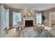 Bright living room featuring hardwood floors, a decorative fireplace, and natural light at 207 Old Forest Creek Dr, Chapel Hill, NC 27514