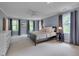 Spacious main bedroom featuring neutral color palette, plush carpet, and plenty of natural light at 207 Old Forest Creek Dr, Chapel Hill, NC 27514