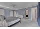 Light-filled main bedroom featuring neutral carpet, ensuite bath, and walk-in closet at 207 Old Forest Creek Dr, Chapel Hill, NC 27514