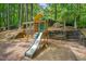 wooden playset surrounded by landscaped greenery at 207 Old Forest Creek Dr, Chapel Hill, NC 27514