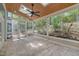 Screened sunroom with outdoor views, skylights, ceiling fan, and brick patio at 207 Old Forest Creek Dr, Chapel Hill, NC 27514