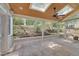 Tiled sunroom with skylights and ceiling fan overlooking landscaped backyard at 207 Old Forest Creek Dr, Chapel Hill, NC 27514