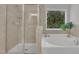 Bathroom featuring a walk-in shower and soaking tub by a window at 2073 Weston Green Loop, Cary, NC 27513