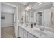 Bathroom featuring a double vanity with a large mirror and overhead lighting at 2073 Weston Green Loop, Cary, NC 27513