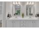 Bathroom featuring double sinks with modern fixtures and white cabinets at 2073 Weston Green Loop, Cary, NC 27513