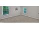 Bright bedroom with two windows and neutral carpeting for a cozy and inviting feel at 2073 Weston Green Loop, Cary, NC 27513