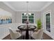 Traditional dining room is illuminated by natural light and features modern furnishings for easy entertaining at 2073 Weston Green Loop, Cary, NC 27513