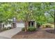 View of the brick facade, two car garage, driveway, and landscaping of this charming townhome at 2073 Weston Green Loop, Cary, NC 27513