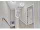 Hallway to bedrooms with neutral walls and carpeted floors that promote a clean and spacious atmosphere at 2073 Weston Green Loop, Cary, NC 27513