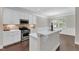 Well-lit kitchen boasts stainless steel appliances, custom cabinets and a breakfast bar for easy meal preparation at 2073 Weston Green Loop, Cary, NC 27513