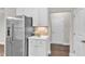 Kitchen featuring stainless steel refrigerator, white cabinets, and hardwood floors at 2073 Weston Green Loop, Cary, NC 27513