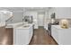 Well-lit kitchen boasts stainless steel appliances and white cabinets at 2073 Weston Green Loop, Cary, NC 27513