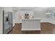 Open kitchen with stainless steel appliances, center island, and white cabinets at 2073 Weston Green Loop, Cary, NC 27513