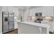 Kitchen featuring white countertops, stainless steel appliances, backsplash, and kitchen island at 2073 Weston Green Loop, Cary, NC 27513