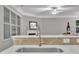 Kitchen featuring a stainless steel sink, wine glasses, and view into living room with fireplace at 2073 Weston Green Loop, Cary, NC 27513